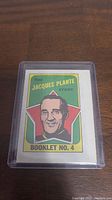 Front cover of the booklet showing the illustrated portrait of Jacques Plante with a red star background, titled 'The Jacques Plante Story Booklet No. 4'