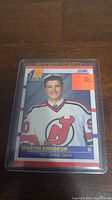 Front of the 1990 Score Martin Brodeur rookie card in plastic sleeve showing player image and rookie indicators.