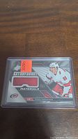 Front of Teuvo Teravainen jersey card featuring a red fabric swatch and player image in Carolina Hurricanes uniform.