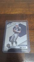 Front of Tom Brady Mosaic football card in plastic protective case.