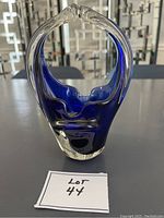 Front view of cobalt blue art glass basket on a flat surface, showing its shape and design.