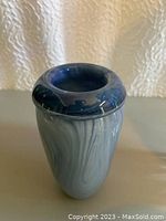 Side view showing overall vase design with blue marbled swirl glass and thick rounded rim.