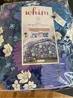 Photo of the full 3-piece comforter set in its original bag showing floral pattern