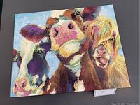 Colorful cow print artwork showing three cows in various colors with a blue sky background on a 16x20 size.