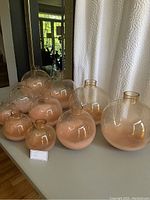 Full set of 10 glass bubble vases arranged on table showing variety of sizes and shape