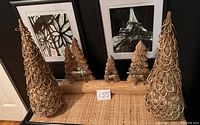 Two large woven wooden trees with a natural wood finish and a wooden base with carved wooden trees and metal deer figurines.