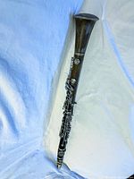 Photo of the full clarinet showing its condition and shape against a light blue background.