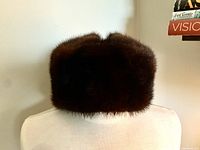 Front view of the brown fur hat showing the dense fur texture and shape.