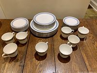 Full set of Royal Doulton Eastbrook china pieces arranged on table.