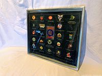 Framed set of baseball pins representing MLB World Series champions with team logos and years displayed inside a silver-tone frame.