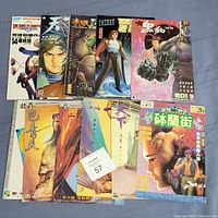 Lot of 11 used anime comics arranged flat showing front covers with various illustrated characters and covers in a non-English language.