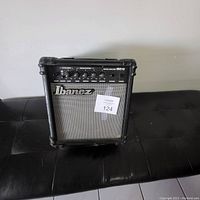Front view of Ibanez IBZ10 guitar amplifier showing mesh grill, logo, and protective corners