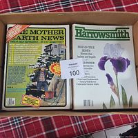 Top down shot of a box containing Mother Earth News and Harrowsmith magazines showing front covers and headlines