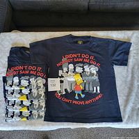 Five navy blue youth medium t-shirts featuring a front graphic of Bart Simpson surrounded by various characters from The Simpsons with red text 'I Didn't Do It. Nobody Saw Me Do It. You Can't Prove Anything.'