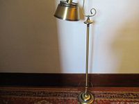 Full view of the brass pole floor lamp showing height and base design.
