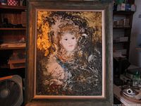 Full view of framed modernist painting featuring two abstract faces, one prominently white and the other more muted, with gilt accents on canvas, in wooden frame.