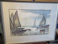 Full view of the framed watercolour showing boats on water under a cloudy sky.