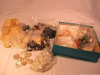 Lot of assorted vintage buttons in plastic bags and teal box, showing various colors and sizes.