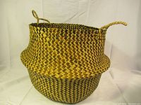 Full view of basket showing its foldable structure, zigzag pattern, and dual handles.