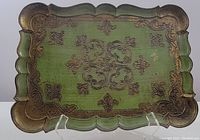 Full view of rectangular Florentine serving tray showing green surface with gold ornate floral and scroll decorations and scalloped edge.