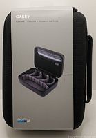 Front view of Casey brand hard case packaging showing product name and photo of open case with customizable interior compartments.
