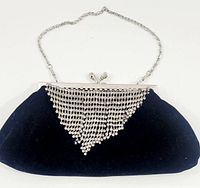 Front view of vintage black velvety evening bag featuring silver rhinestone triangular drape and chain strap
