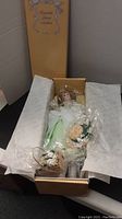 Lily doll in original box with flower accessories and tissue paper wrapping