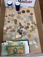 Full lot with coins scattered and paper currency visible