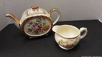 Front and side views of Sadler 1730 BH teapot showing floral designs and gold accents