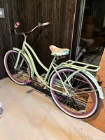 Side profile of bicycle showing step-through frame, colors and rear rack