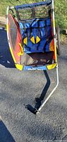 Front view showing seat with harness and metal frame