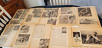 Several vintage newspaper clippings spread out on a wooden table, featuring black and white photos and articles about Babe Ruth in various poses and game actions.
