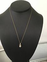 Necklace displayed on black bust showing overall design