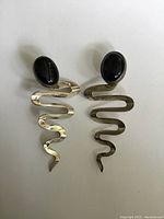 Photo of pair of Mexican sterling silver zig zag earrings with oval black onyx stones on plain white background