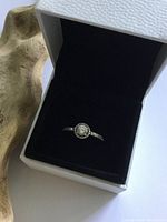 Pandora sterling silver solitaire ring shown in open white box with black velvet interior.
