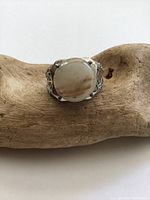Front view showing the round cabochon agate stone set in sterling silver with detailed filigree band.