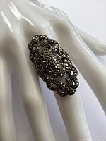 Close-up of the vintage sterling silver marcasite ring showing the ornate filigree and marcasite stones on the front oval area.