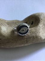 Front view of the sterling silver ring with 'seeing eye' design and gem accents.