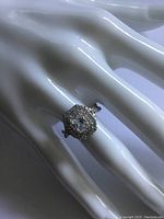Close-up photo of the sterling silver engagement style ring showing the detailed crystal setting on a white mannequin hand.