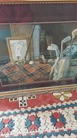 Full view of the framed golf artwork showing the plaid cloth surface, golf clubs, balls, and framed golfer photo.