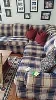 Full view of Broyhill sectional sofa with plaid fabric upholstery showing pattern, cushion seating, and included throw pillows.