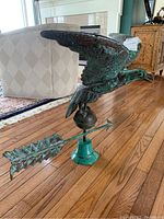 Angled front view showing eagle in flight and arrow pointer