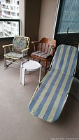 Wooden chair, two patio chairs including a rocker and a lounger, and small white plastic patio table viewed from side and front on balcony.