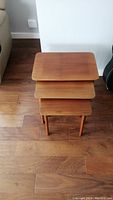 Stacked set of three wooden nesting tables viewed from above