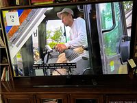 Samsung 65” TV powered on displaying a show
