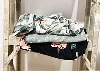Stacked view of the three pairs of bike shorts showing different patterns and colors.