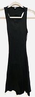 Black bodycon dress hanging on a hanger, sleeveless with a scoop neckline