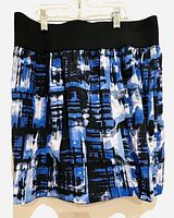 Front view of Le Chateau skirt showing abstract blue, black, and white pattern and elastic black waistband.