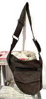 Front and side view of The Fairies Pyjamas dark brown cross body fanny pack with adjustable velcro strap
