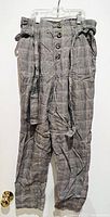 Full front photo of checkered high-waisted capris showing button closure and fabric belt
